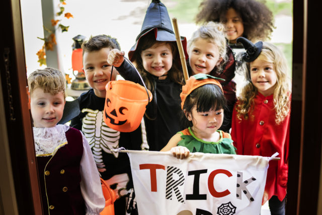 Little children trick or treating on Halloween