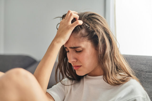 Close-up of a sad woman with anxiety and depression. Mental health concept.
