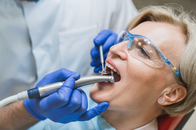 Side view portrait of perfect ideal healthy smile. Stomatological dental equipment, dentist whitening filling tooth teeth of female patient at dental hospital
